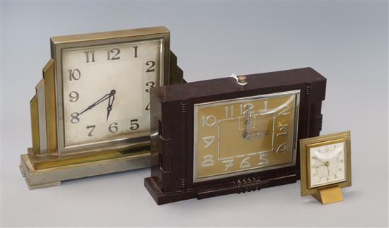 A chrome and brass mantel clock, Bakelite clock and an alarm clock